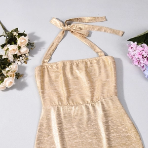 Detailed view of the metallic gold ribbed fabric and shimmering texture of the party dress