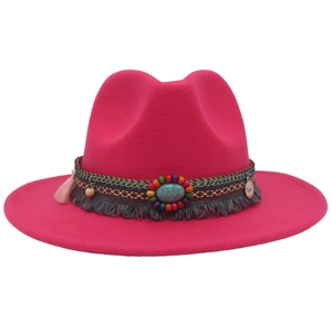 Macro detail of fuchsia fedora with turquoise beadwork and ethnic fringe trim