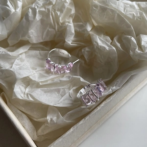 Macro shot of S925 sterling silver ring with pink gemstone in premium paper packaging