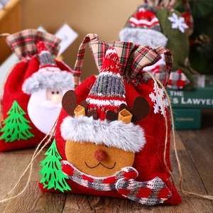 Detailed view of knitted Christmas gift bags with Santa and reindeer on wooden background