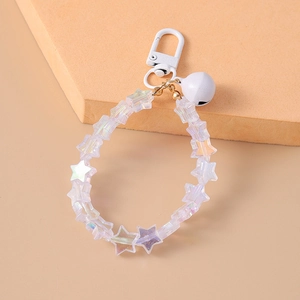 Close-up of star-shaped beads keychain with white bell and painted lobster clasp