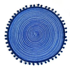 Blue and white woven round placemat with navy blue pom pom tassel fringe trim decor
