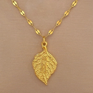Detailed close-up of leaf pendant with engraved Camellia characters on bamboo chain