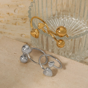 Minimalist open heart and sphere rings set in polished gold and silver finishes