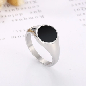 Modern silver stainless steel ring with black round seal face, 45-degree angle product view