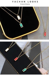 Detail of colorful rectangular zircon pendants on gold stainless steel chains