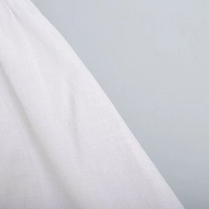 Detailed macro view of white cotton linen fabric with natural grid texture and soft drapes