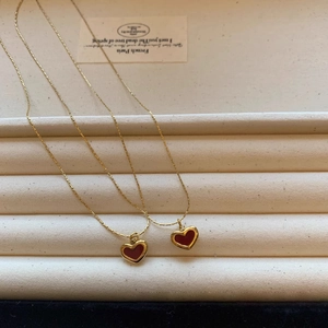 Elegant gold titanium necklace set with red heart pendants in minimalist French style