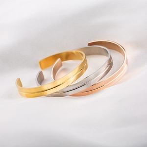 Three-piece minimalist C-shaped stainless steel bracelets in gold, silver, and rose gold finishes