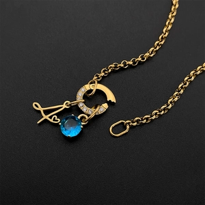 Elegant gold titanium steel necklace featuring a blue gemstone and script letter A charm