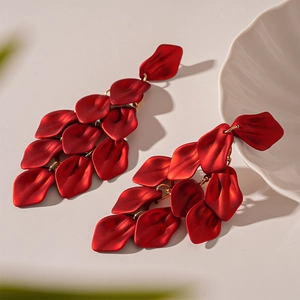 Detailed close-up of matte red petal tassel earrings with elegant layered design