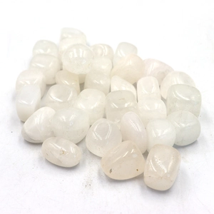 Macro shot of natural tumbled white crystal stones with polished irregular surfaces
