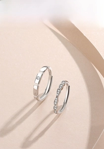 Detailed macro view of S925 sterling silver couple rings showing the S925 material hallmark