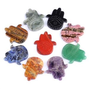 Nine natural crystal Hamsa Hand carvings including Amethyst and Rose Quartz on white