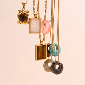 Vertical view of 18K gold plated necklaces featuring tiger eye and turquoise pendants