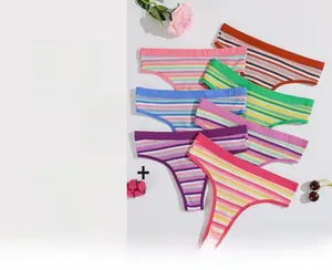 Flat lay of colorful seamless cotton thongs for women featuring various vibrant rainbow colors