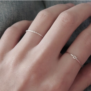 Minimalist 925 sterling silver olive bead and knot open rings for women on denim background