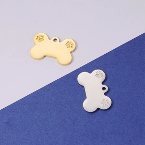 Mirror polished bone-shaped stainless steel pet tags in gold and silver with paw prints
