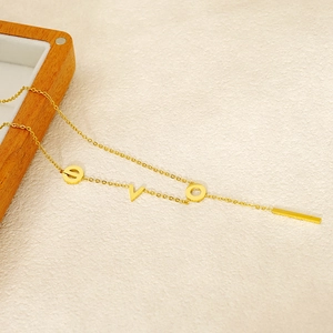 Elegant gold stainless steel LOVE letter necklace on a minimalist jewelry display