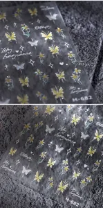 Detailed macro of gold-stamped butterfly and floral nail art stickers M-682 with holo gloss