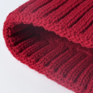 Thick red jacquard knit beanie for women with warm fleece lining and protective ear flaps
