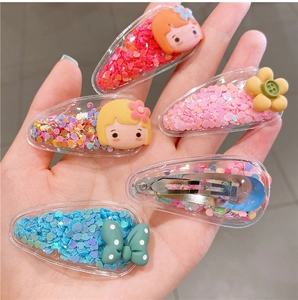 Detail of five colorful acrylic fruit hair clips for girls with sequins and cartoon decor
