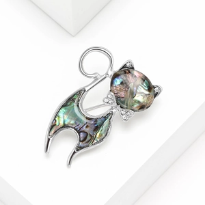 Cat brooch with natural abalone shell and sparkling rhinestones on a white background