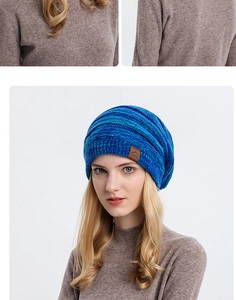 Close-up of blue knitted beanie featuring a leather patch with a mountain logo