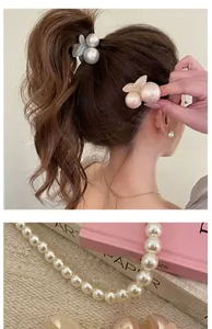 Detailed close-up of cherry blossom pearl hair clips and elegant bead necklace jewelry set