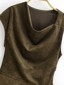 Detail view of dark brown faux suede dress featuring a soft draped neckline and rich texture