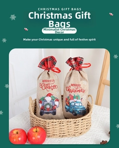 Detail of Christmas burlap gift bags featuring red plaid trim and festive Santa truck print