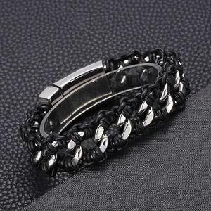Macro shot of silver stainless steel Cuban chain woven with black leather for men