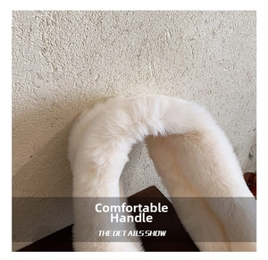 Detail of plush faux fur handle in cream white showing soft fluffy texture