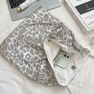 Silver leopard canvas tote bag interior detail showing magnetic closure and white lining