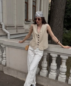 Detailed view of women's linen blend sleeveless vest top with single-breasted buttons