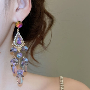 Macro shot of sparkling crystal tassel earrings with colorful iridescent hanging gems