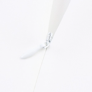 Detail of invisible zipper closure on an elegant white pearl cowl neck fishtail dress