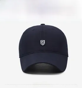 Detail view of navy blue baseball cap featuring white embroidered R logo and breathable holes