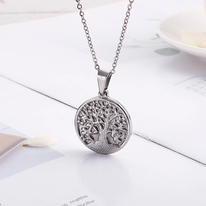 Close-up of a silver Tree of Life pendant necklace on a polished stainless steel chain