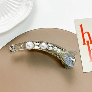 Detailed view of clear mermaid tail banana hair clip with pearls and rhinestones decoration