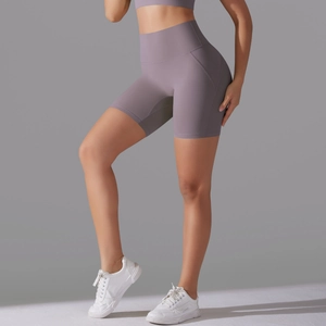 Detail view of dark purple high-waisted yoga shorts with ergonomic curved side stitching