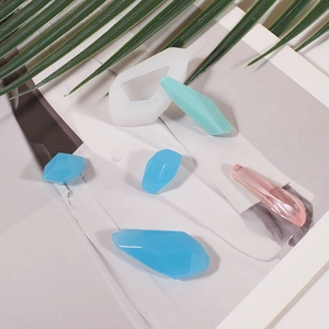 Detail of faceted stone resin molds and colorful crystalline pendants on a magazine page