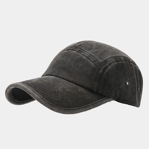 Detail of washed cotton baseball cap showing metal eyelets and reinforced stitching