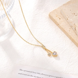 Elegant gold heart pendant necklace with zircon crystals on a minimalist link chain