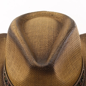 Close-up of vintage straw cowboy hat with colorful floral embroidery on the decorative band