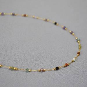 Minimalist gold chain necklace with multi-color natural stones in a vintage style