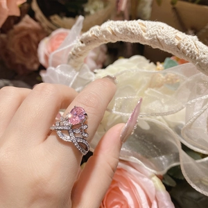 Close-up of 18K gold plated crown ring featuring a large pink pear-cut gemstone for women