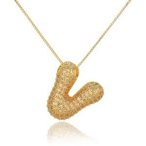 Close-up of golden bubble letter L pendant necklace paved with sparkling zircons