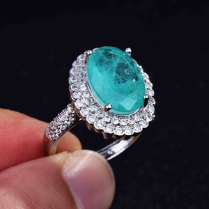 Macro detail of pear-cut Paraiba tourmaline ring with double halo pavé setting