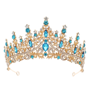 Detailed view of royal gold crown featuring vibrant blue crystals and white rhinestones